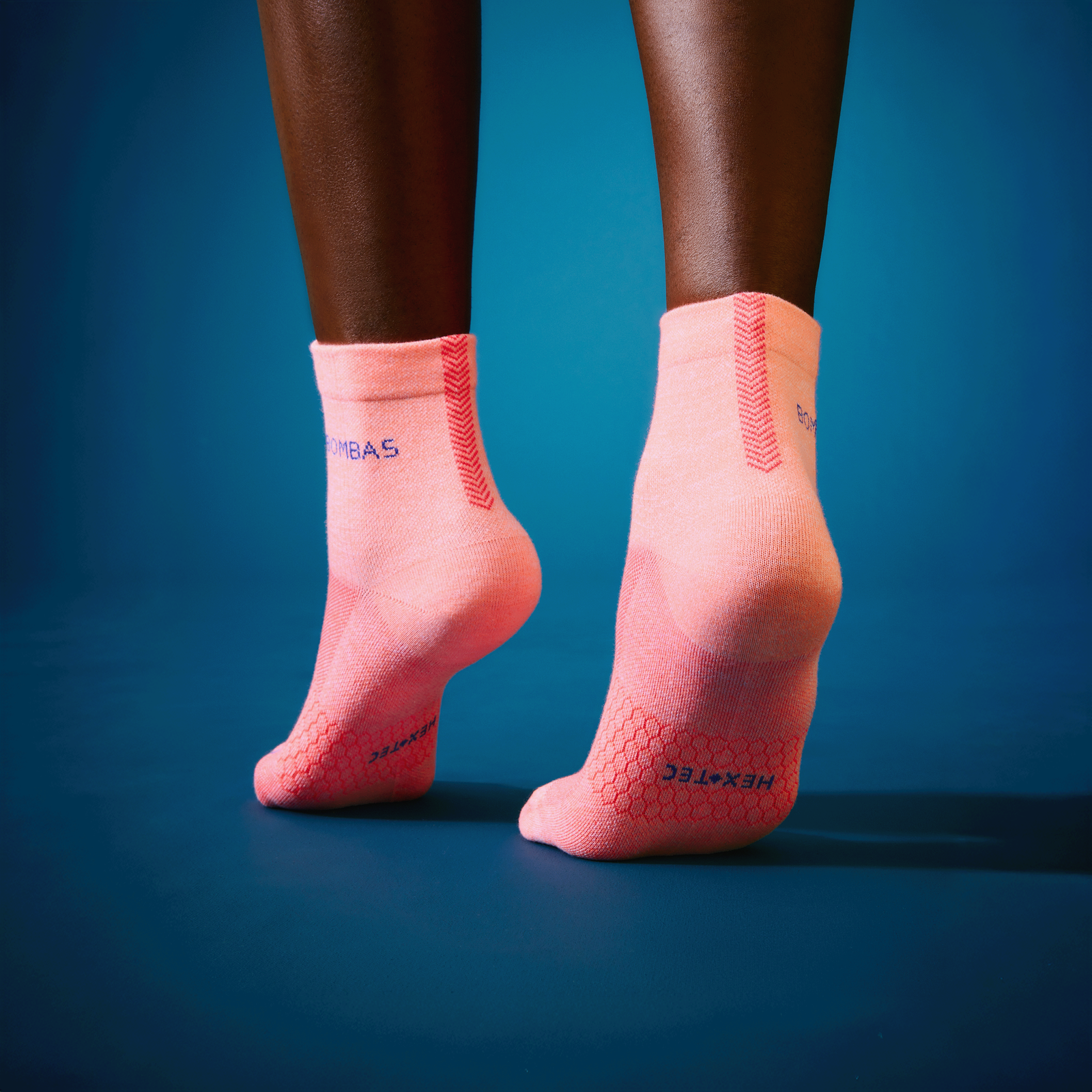 official-bombas::10073-neonpeach-white-adult-unisex-onmodel-0-transparent-v3.png